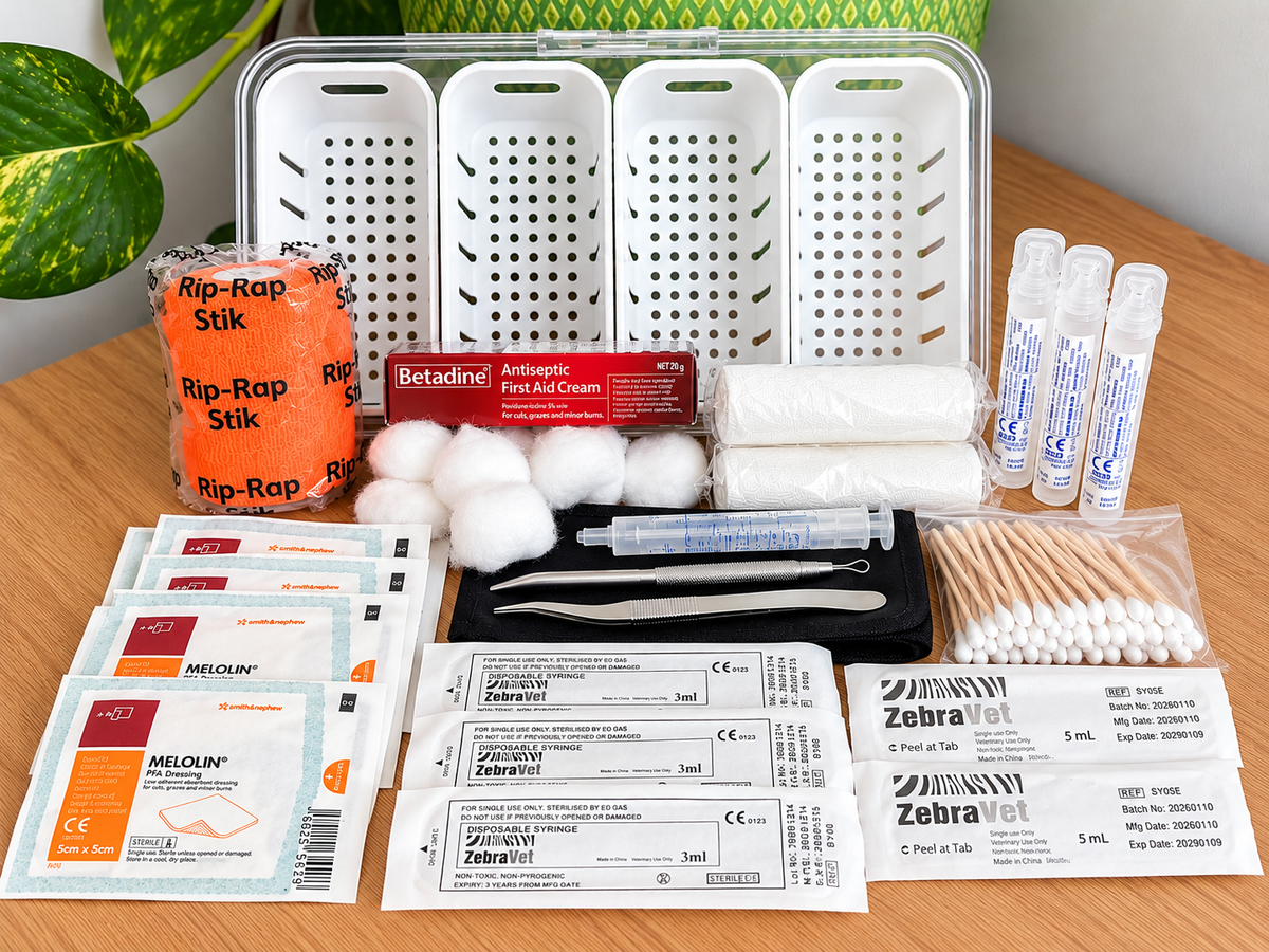 Henmergency first aid kit contents arranged on wooden table